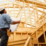 image of a home inspector conducting a pre-drywall inspection of a house with wooden structure