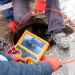 image of an inspector doing a sewer scope inspection